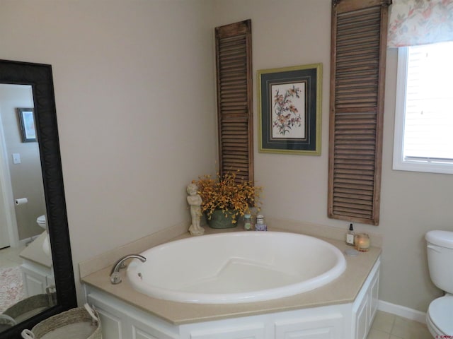 bathroom with a bathing tub, a healthy amount of sunlight, and toilet