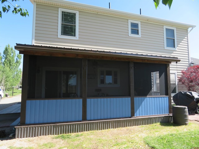 back of property featuring a sunroom