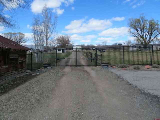 view of gate with a lawn