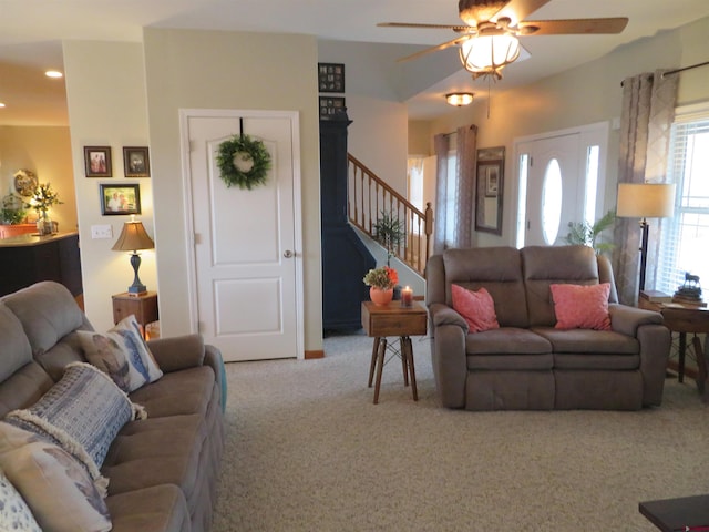 carpeted living room with ceiling fan