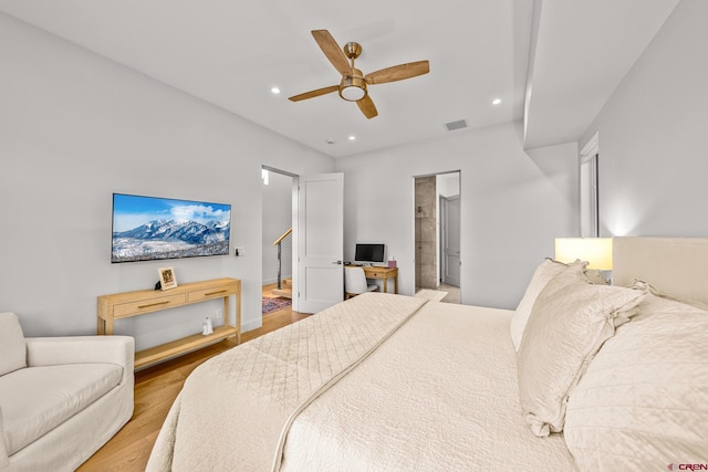 bedroom with hardwood / wood-style flooring, ceiling fan, and ensuite bathroom