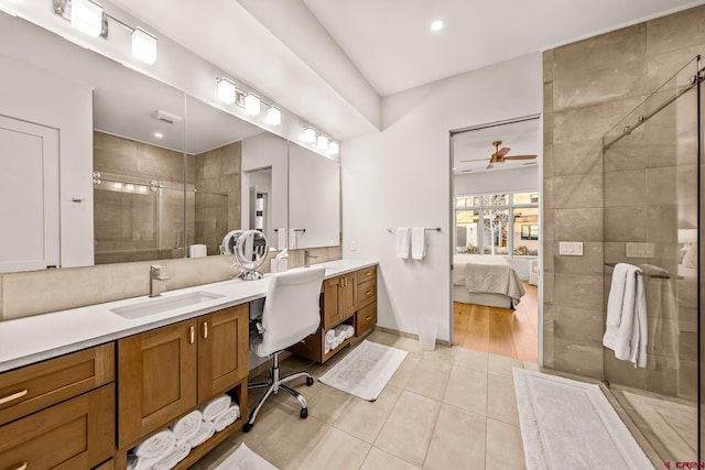 bathroom featuring tile patterned floors, ceiling fan, vanity, and a shower with shower door