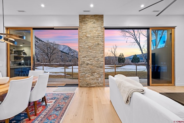 dining area featuring a mountain view and wood-type flooring