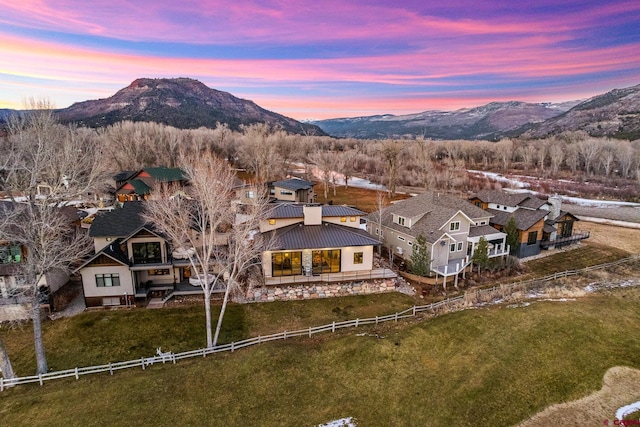 aerial view at dusk featuring a mountain view