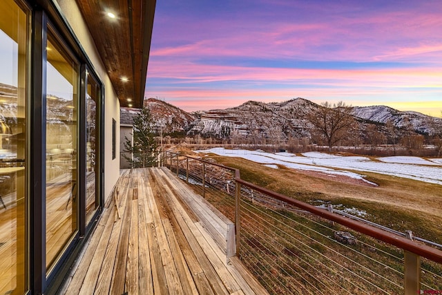 snow covered back of property with a mountain view