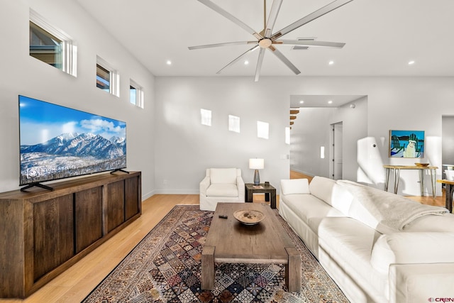 living room featuring ceiling fan and light hardwood / wood-style flooring