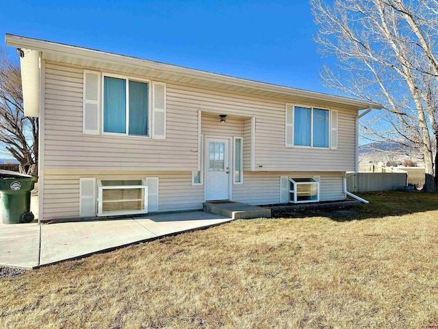 raised ranch with a patio area and a front yard