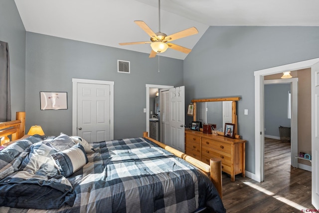 bedroom with ceiling fan, dark wood-type flooring, and vaulted ceiling