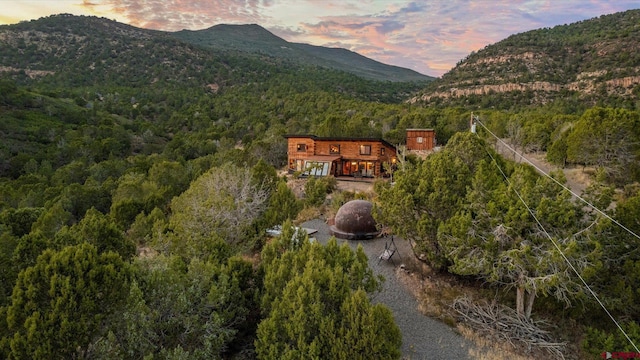 aerial view at dusk featuring a mountain view