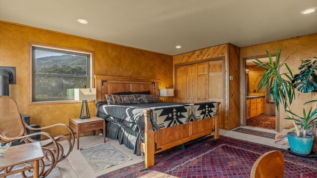 bedroom with wooden walls and a closet