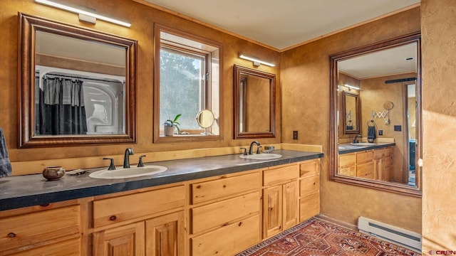 bathroom with vanity and baseboard heating