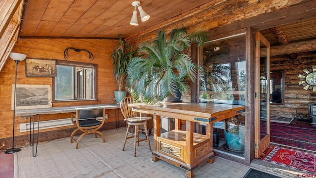 sunroom with lofted ceiling, plenty of natural light, and wood ceiling