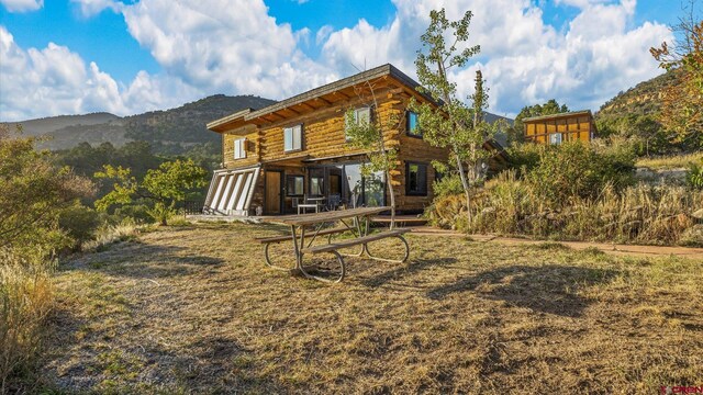 back of property with a mountain view