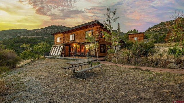 back house at dusk featuring a mountain view