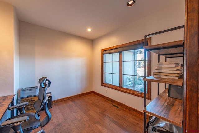 home office with dark hardwood / wood-style floors