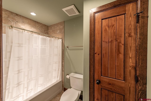 bathroom featuring shower / bath combo and toilet