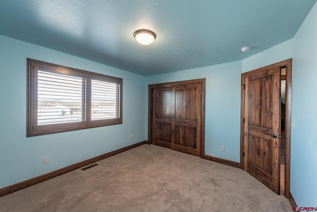 unfurnished bedroom with light colored carpet