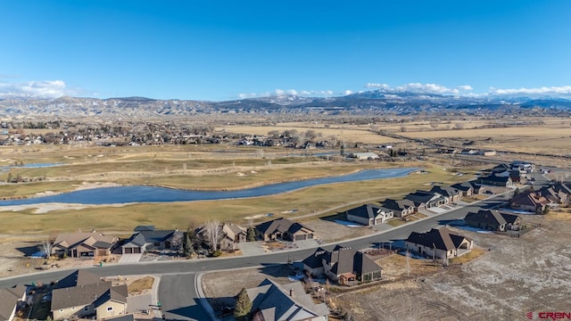 birds eye view of property featuring a water and mountain view