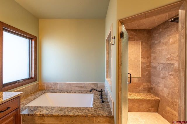 bathroom with vanity and separate shower and tub