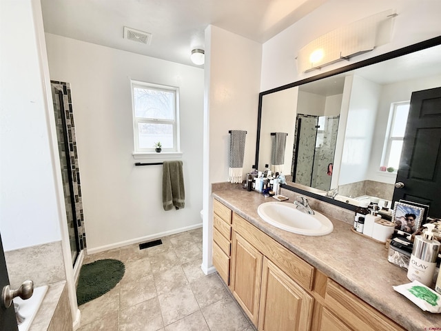 bathroom with tile patterned flooring, vanity, and shower with separate bathtub