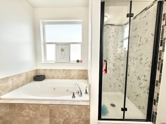 bathroom featuring plus walk in shower and plenty of natural light