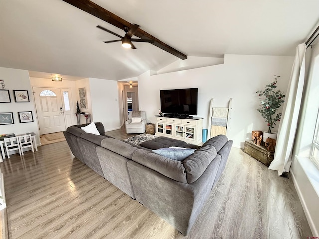 living room with vaulted ceiling with beams, hardwood / wood-style flooring, and ceiling fan