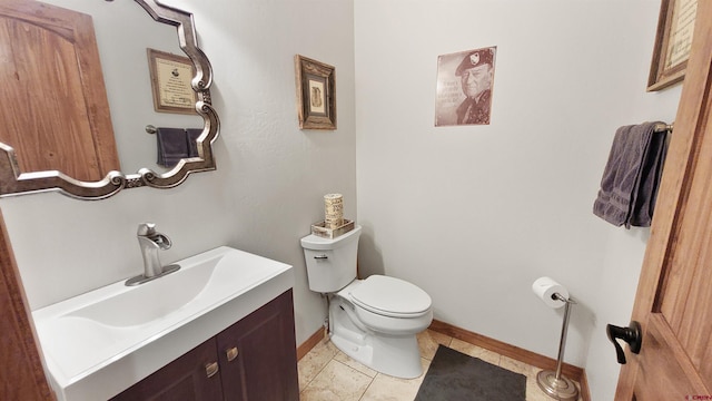 bathroom featuring tile patterned flooring, vanity, and toilet