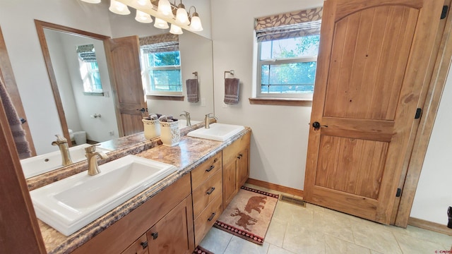 bathroom featuring tile patterned flooring, vanity, and toilet