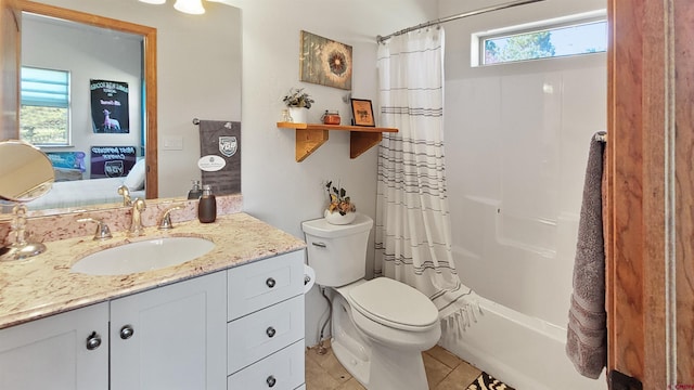 full bathroom featuring tile patterned flooring, vanity, toilet, and shower / tub combo