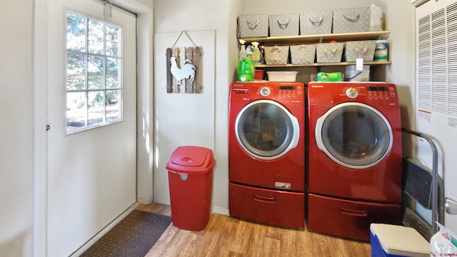 washroom featuring washer and clothes dryer and light hardwood / wood-style flooring