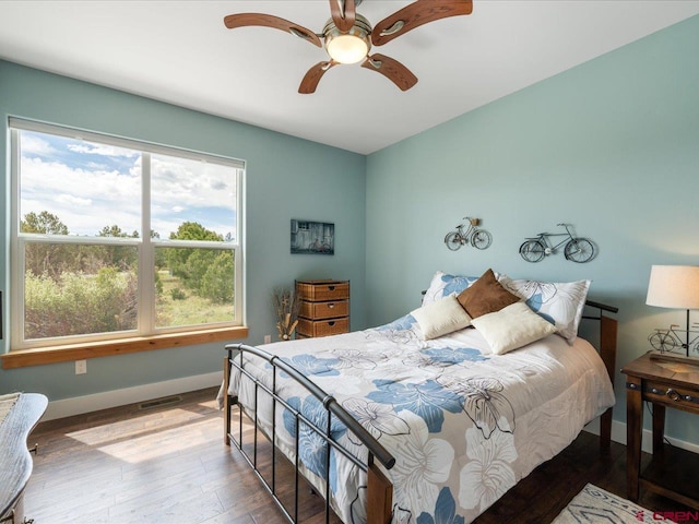 bedroom with ceiling fan and hardwood / wood-style flooring