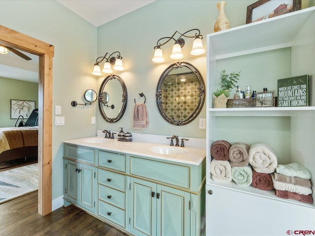 bathroom with hardwood / wood-style flooring, ceiling fan, and vanity