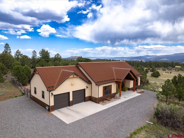 view of front facade featuring a mountain view and a garage