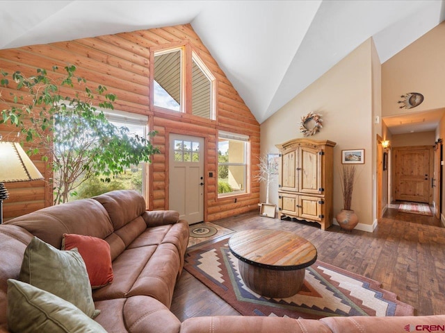 living room featuring log walls, lofted ceiling, and dark wood-type flooring