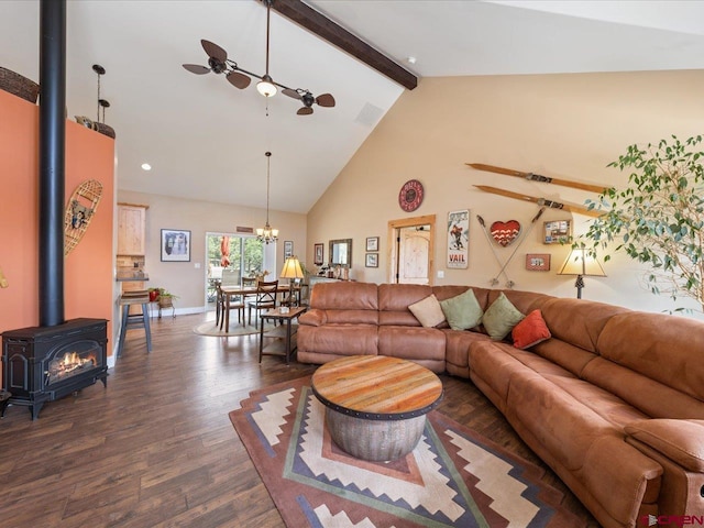 living room featuring beam ceiling, a wood stove, high vaulted ceiling, dark hardwood / wood-style floors, and ceiling fan with notable chandelier