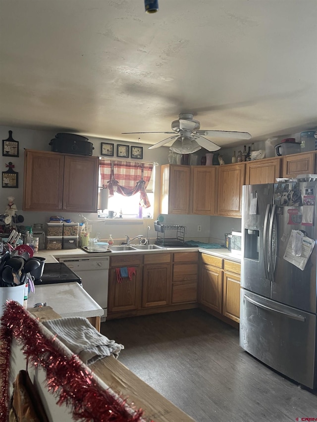 kitchen featuring dark hardwood / wood-style floors, stainless steel fridge, sink, and ceiling fan