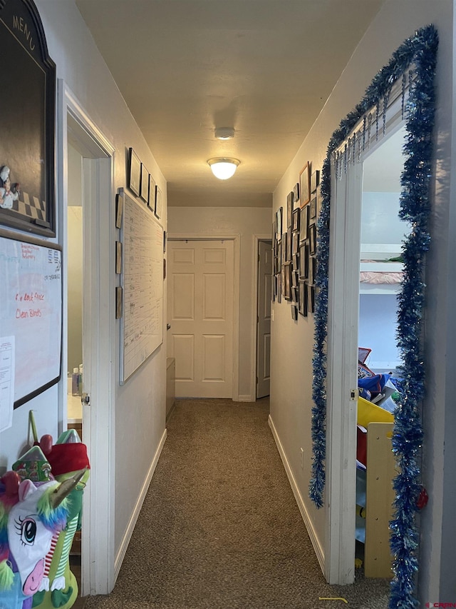 corridor featuring dark colored carpet