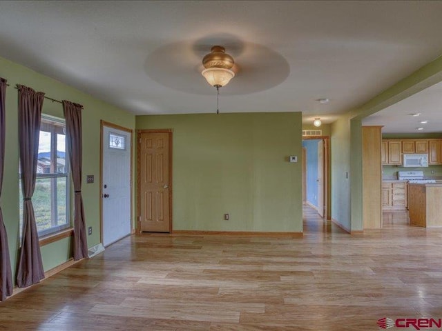 interior space featuring light wood-type flooring and ceiling fan