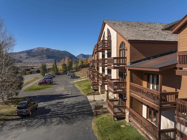 view of home's exterior with a mountain view and a balcony