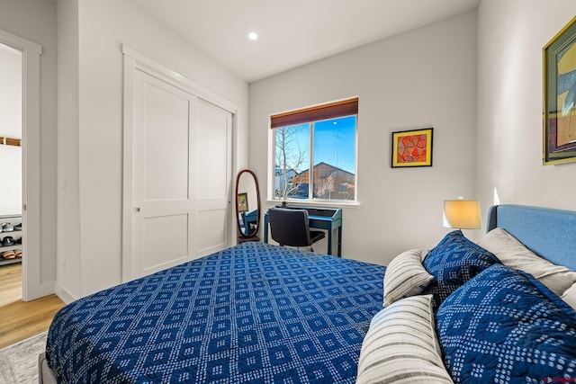 bedroom with hardwood / wood-style flooring and a closet