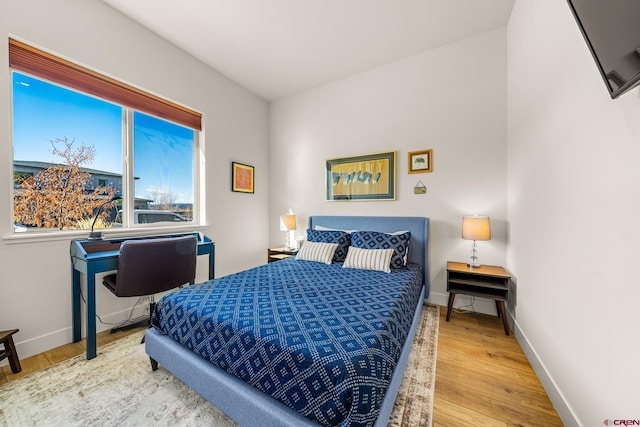 bedroom with wood-type flooring