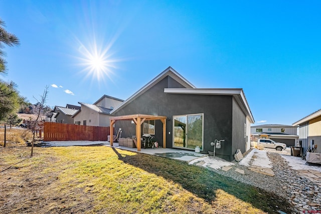 back of house featuring a yard and a patio