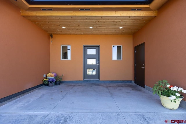 view of exterior entry with a carport