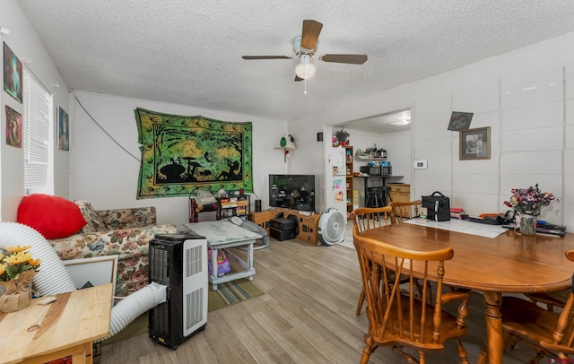 dining area featuring ceiling fan, a textured ceiling, and light hardwood / wood-style flooring