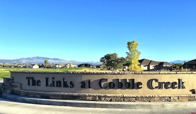 community sign featuring a mountain view