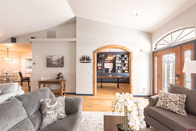 living room with hardwood / wood-style floors and vaulted ceiling