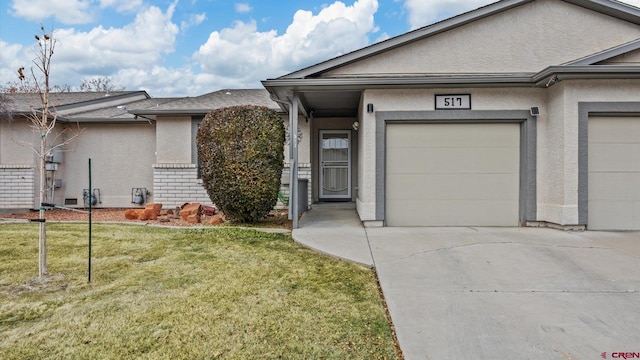 entrance to property with a yard and a garage