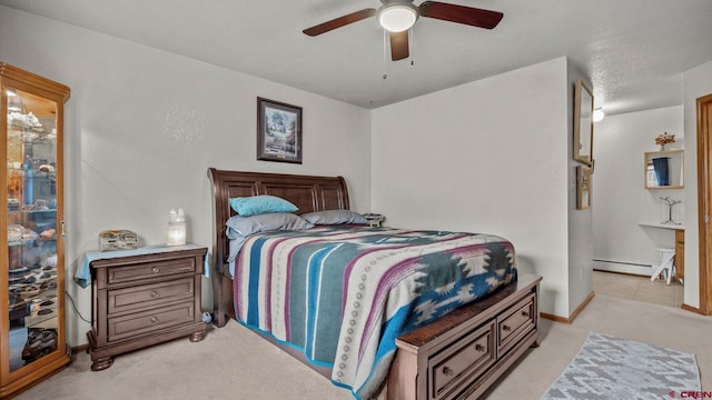 bedroom with ceiling fan, light colored carpet, and a baseboard radiator