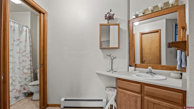 bathroom with toilet, vanity, tile patterned floors, and baseboard heating