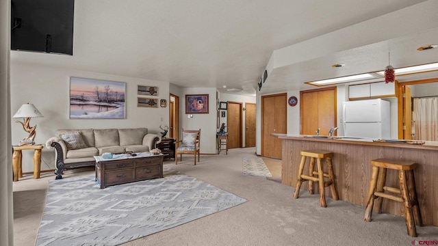 living room with light carpet and sink